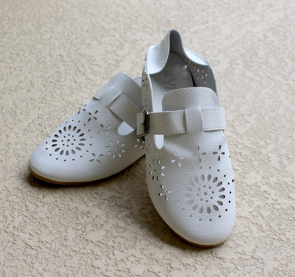White cutwork style shoes before painting