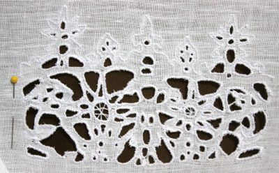 Cutwork lace in white cotton thread on white linen