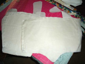 The padded interlining basted to muslin.