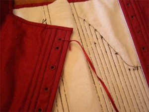 Tie the cord to the garment, through the starting eyelet