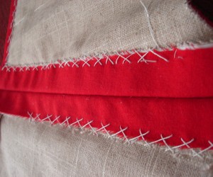 Sewing down seam allowances with the herringbone stitch.