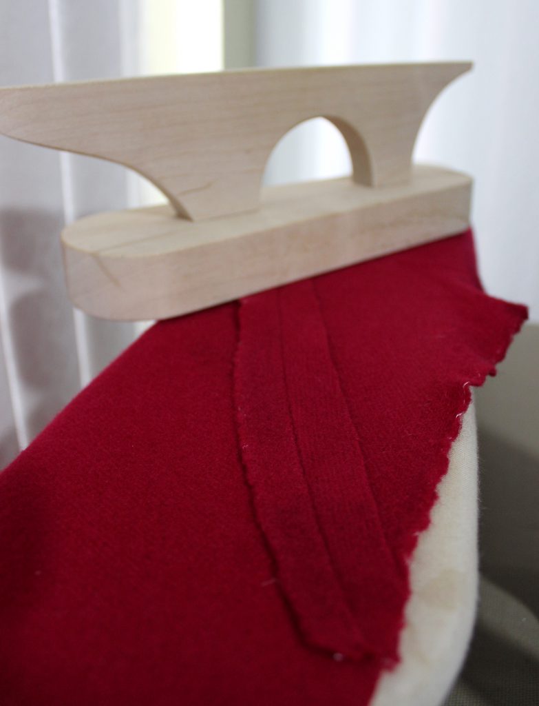 Flattening the petticoat skirt seams with a wooden clapper