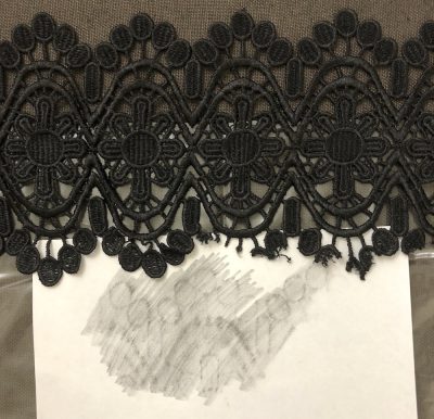 Black lace and white paper rubbing